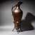 Decorative large vessel in hammered copper with a long handle and conical body. The tripod base is made of iron and...