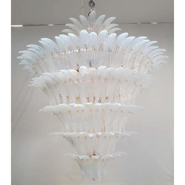 Italian chandelier shown with opaline hand blown Palmette Murano glass leaves arranged in six tiers including a crown at...