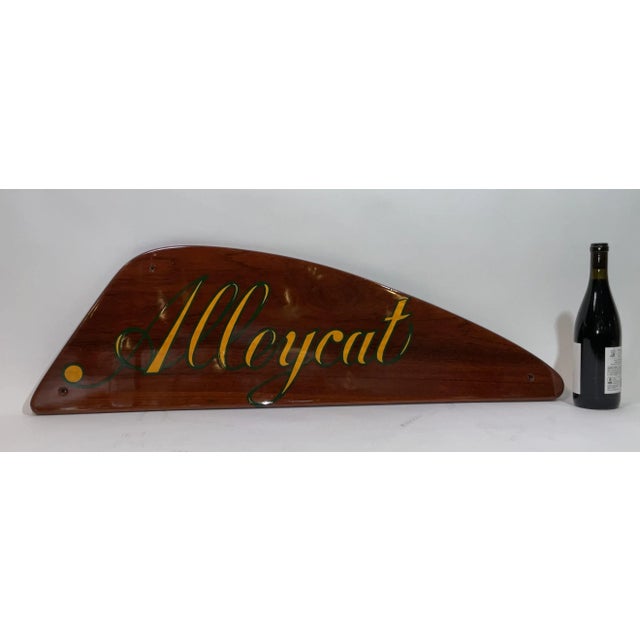 Mahogany boat nameboard from the yacht Alleycat. The name is hand painted in a fancy script. Pierced with three mounting...