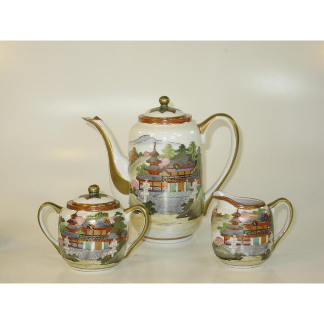 This antique tea set from Japan dates back to the 1800s and features a Kutani design with a House and landscape theme....