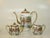 This antique tea set from Japan dates back to the 1800s and features a Kutani design with a House and landscape theme....