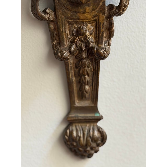 Ornate antique cast bronze three-light wall candle sconce in the Louis XVI / Neoclassical Revival taste, likely dating to...
