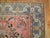 20th century Persian Malayer rug featuring a paradise floral motif on a pink ground surrounded by a soft blue border,...