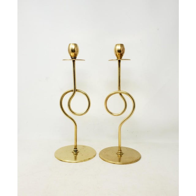 Here is a pair of antique 13-inch-tall brass candlesticks made prior to 1930. These are incised on the bottom: Compliments...