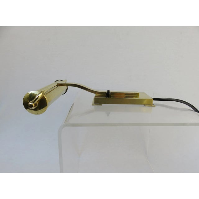 - Made of polished brass and has a cubist reduced design - Socket E14 - The shade can be rotated 360 degrees so that the...