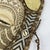 A beautiful face mask with on a beaded plaque, usually hung in a healer's house. Ornate patterns of shells and glass beads...