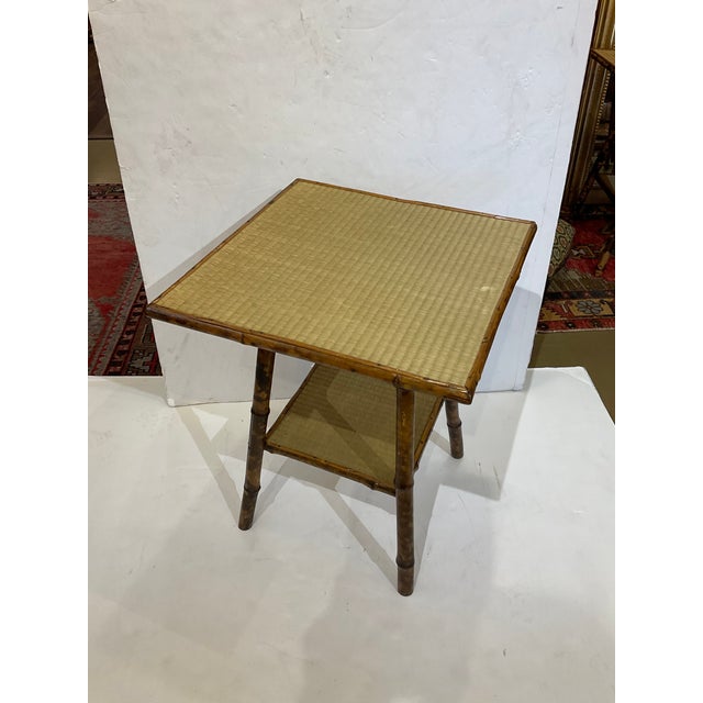 This is a stunning 19th Century English tortoiseshell two tier shelf bamboo side table. Bamboo is the one of the most...