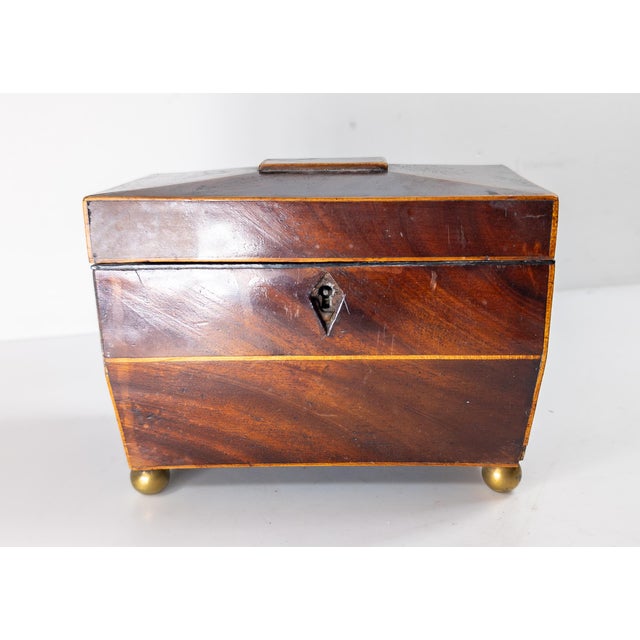 We are selling this nice simple English Regency Mahogany sarcophagus form tea caddy. The caddy has nice mahogany veneer...