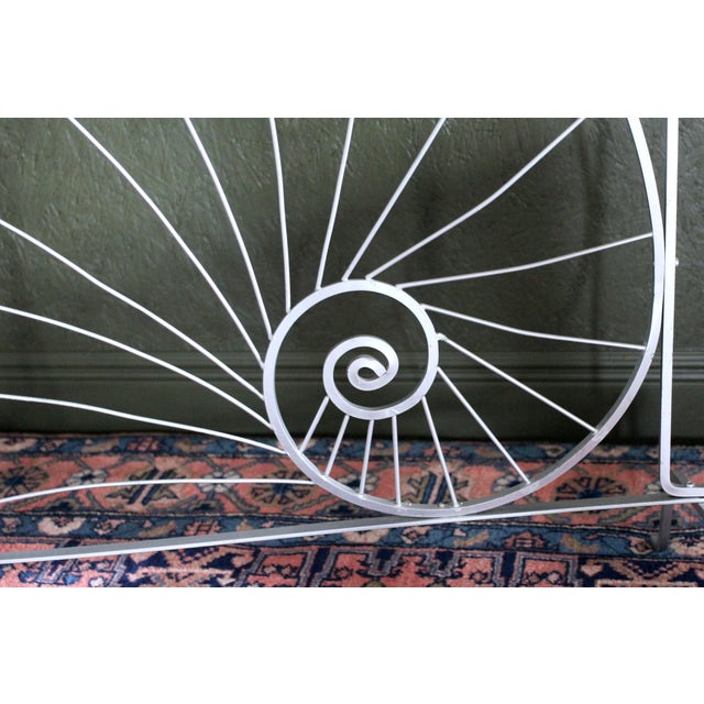 A statement fireplace screen that is shaped like a nautilus shell. Stylized line drawing in metal. Lightweight and great...