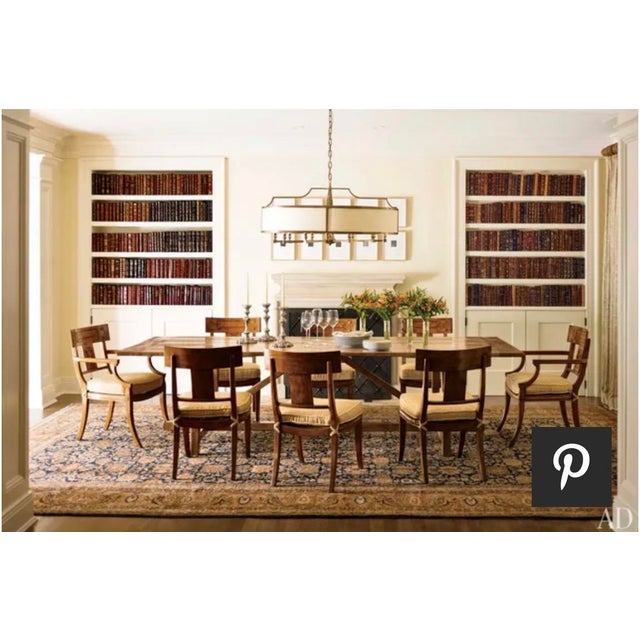 Paul Ferrante “Crescent Heights” pendant chandelier featuring an elegant architectural metal frame with a warm bronze...