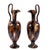 High looping handles sweep prominently above the pinched pouring lips of this Victorian pair of decorative ewers. Each...