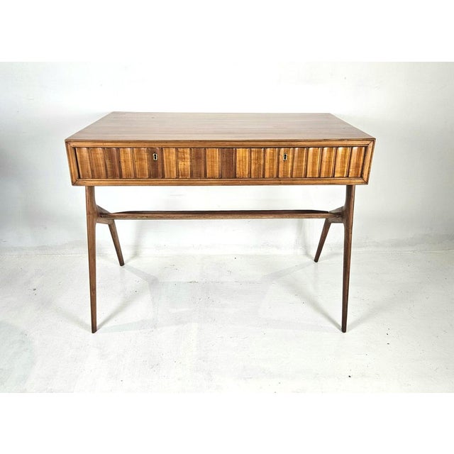 The desk in cherry and birch wood features one long, seamless front drawer, offering generous concealed storage while...