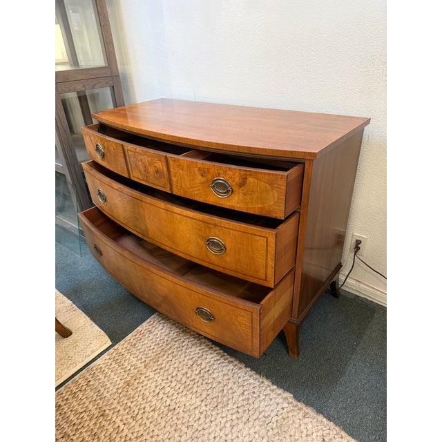 Design Plus Gallery present a Vintage Walnut Dresser from Johnson Furniture Company. The dresser has a distinctive bowed...