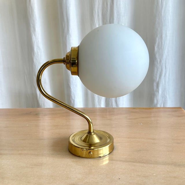 Cute hungarian industrial brass wall light with spherical milk glass shade, 1970s. Brass matched with milk glass...