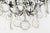 A Louis XV style six-light chandelier with an assortment of crystals with rosettes, including French pendalogues and large...