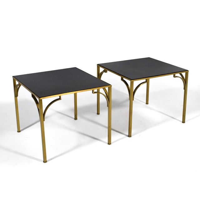 This handsome pair of German end tables have exquisitely crafted brass bases which support inset tops of black Detopak...