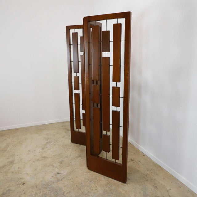 We offer this folding screen made in solid wood with brass details, circa 1950.