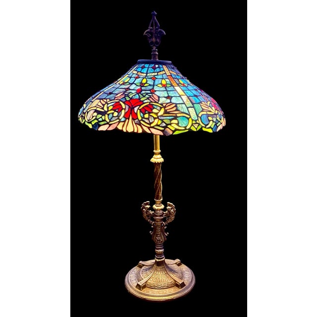 An antique Art Nouveau decorative leaded glass table lamp, likely designed and created by Duffner & Kimberly, featuring a...