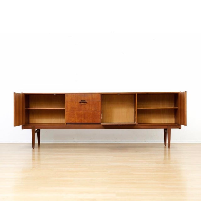 This Vintage teak credenza by Nathan Furniture is a striking piece made by the renowned British furniture maker. This...