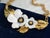 Bold and elegant vintage necklace by Louis Feraud, Paris, featuring two large white flowers with black stamens and gold...