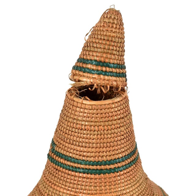 The Tutsi Tight Weave Basket with Lid from Rwanda epitomizes the artistry and tradition of the Tutsi community's weaving...