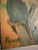 Lovely figurative painting of a beautiful woman sitting on what I imagine to be a beach or seaside cliff at sunset....