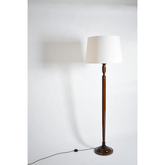 Art deco mahogany floor lamp, 1940s. Art deco mahogany floor lamp with a hexagonal stem resting on a circular base....