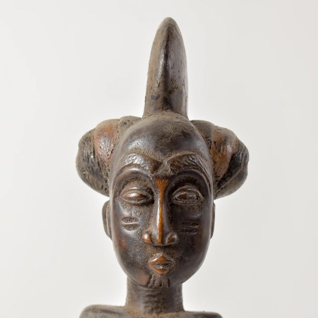 The Kulango Female Figure from Cote d'Ivoire is made from beautifully carved wood with intricate details. This rare piece...