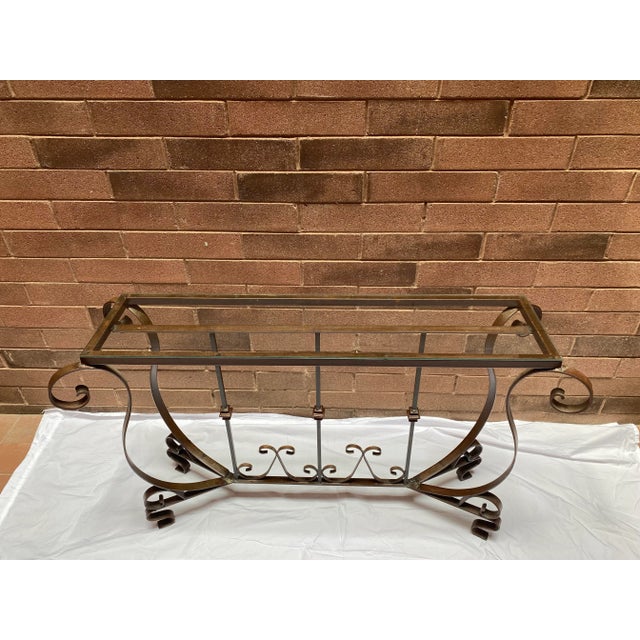 Vintage hand forged wrought iron garden solarium console table. 54” wide x 16” deep x 31” tall Glass top measures 48” x 12”