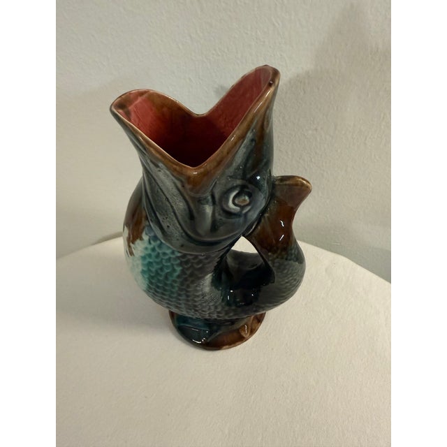 A stunning gurgling fish pitcher. Beautiful majolica fish form pitcher, teaturing dramatic color palette of greens and...
