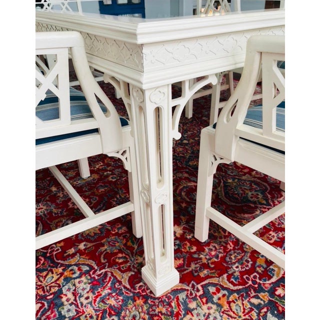 A fabulous vintage Regency dining table featuring an intricately carved wood frame. Stunning lattice legs featuring lovely...