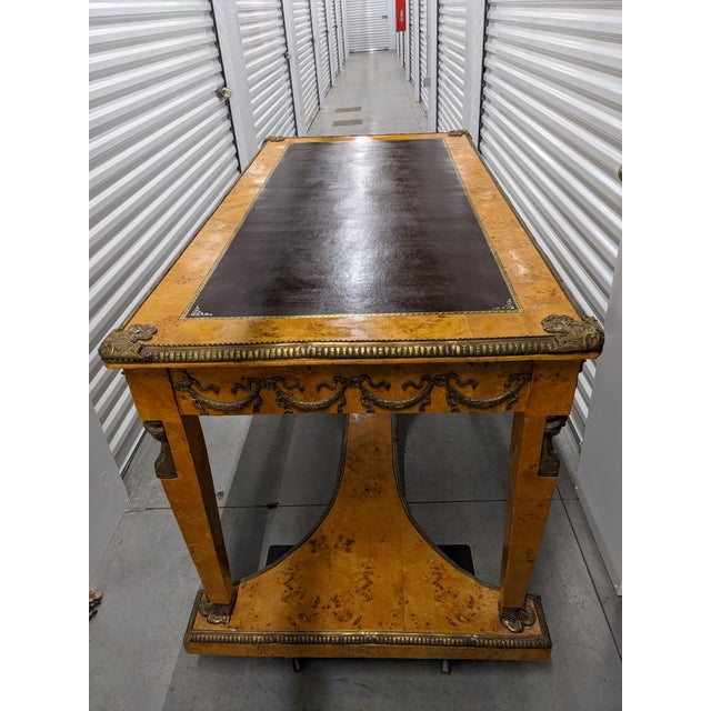 An antique French bureau plat, from late 19th century, featuring ornate gilt-bronze mounts, figural busts on the legs,...