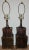 This listing is for TWO circa 1980s unbranded metal table lamps, styled to look like stacked old leather steamer/travel...