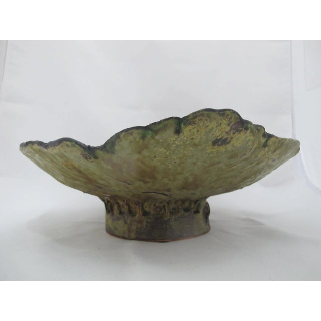 Vincent Suez studio art pottery sculpture. Footed bowl with irregular shape showing a colorful abstract enamel design on...