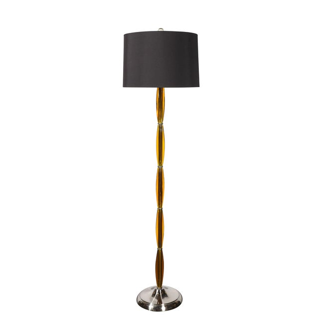 This elegant Pair of Mid-Century Segmented Amber Bakelite & brushed Chrome Floor Lamps originated in the United States,...