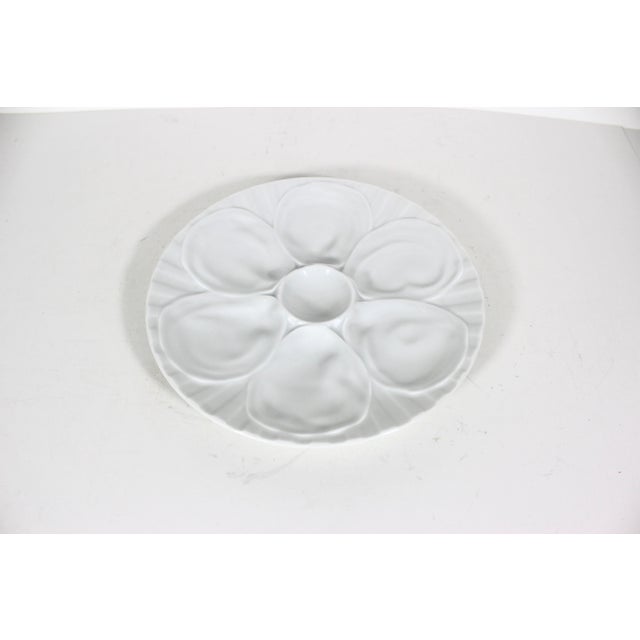 This is a vintage French Pillivuyt white porcelain oyster plate. Maker’s stamp on the underside. Has a small chip on the...