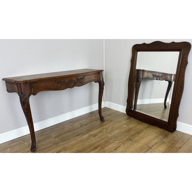 An elegant Antique French Louis oak console table with mirror , combining a beautifully shaped console with decorative...