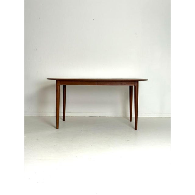 Danish Extendable Teak Dining Table – 1960s An elegant Danish teak dining table dating from the 1960s , characterised by...