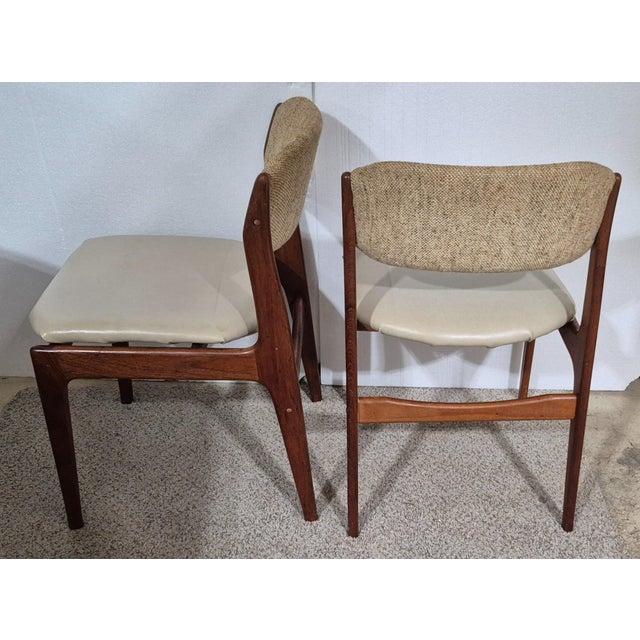 A pair of hardwood dining chairs designed by Erik Buch [pair] 1960s and produced by Oddense maskinsnedkeri A/S in Denmark....