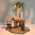 The small bulb in the palm tree illuminates an Arab scene with 2 figures, a camel and a well. Marked Austria on the...