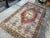 This is a vintage Turkish Oushak rug from the 1960s. The piece was hand-knotted.