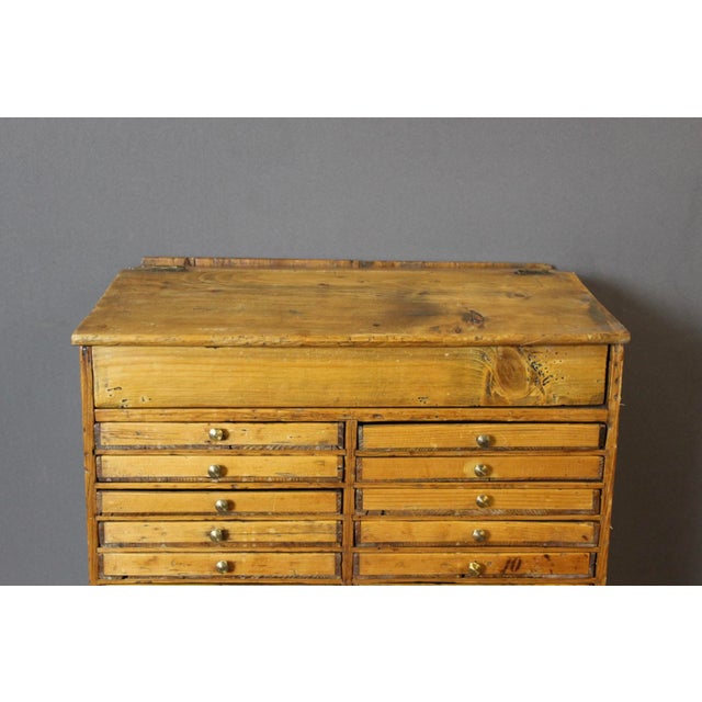 A 28-drawer fir cabinet, a watchmaker's cabinet, it opens with a drop-front, 8 large drawers and 20 small drawers, first...