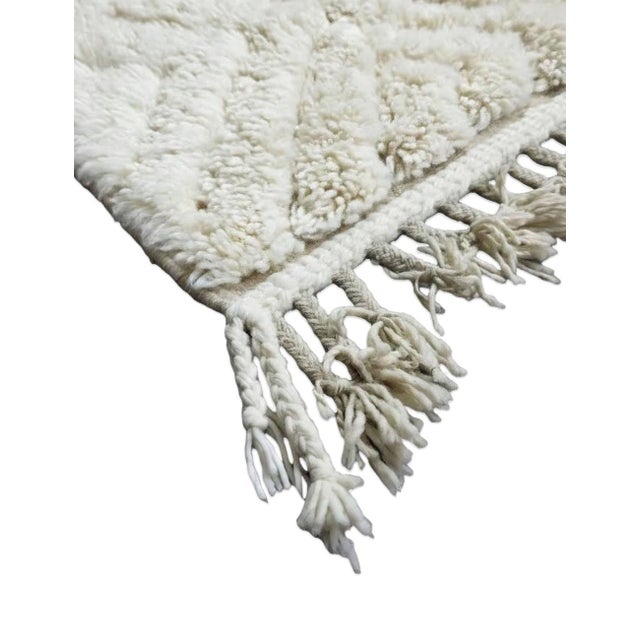 White Moroccan Runner Rug – Handmade Berber Wool Carpet This elegant handmade Moroccan runner rug features a soft white...