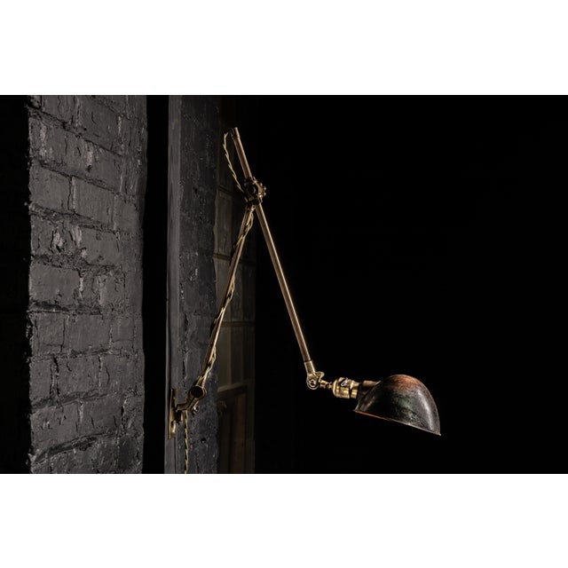 Antique brass articulating lamp manufactured by O.C. White. O.C. White began making lamps to improve his visibility in...