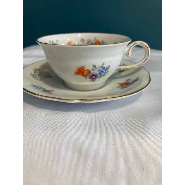 Very beautiful painted orange, blue and yellow flowers. Gilt edging and painted gold scrollwork. Made in US Zone Germany