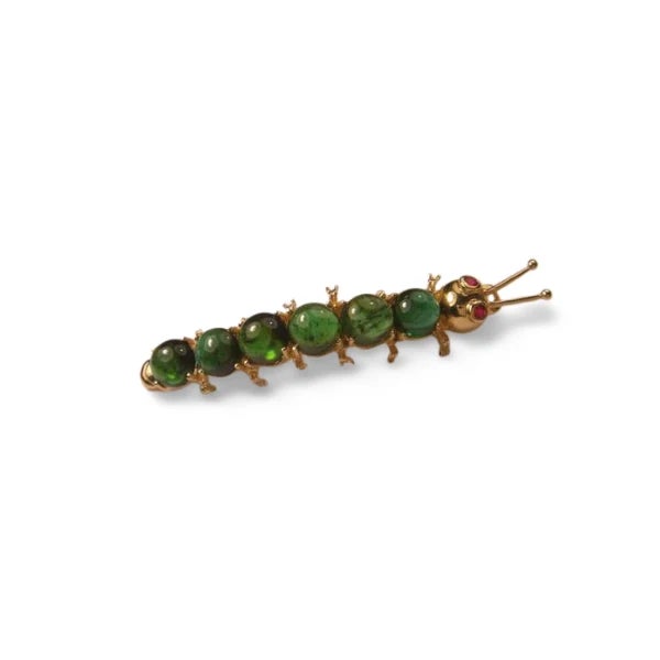 Material: 14K Yellow Gold Gemstones: 6 Natural Cabochon Peridots, 2 Rubies Design: Caterpillar-inspired brooch pin...