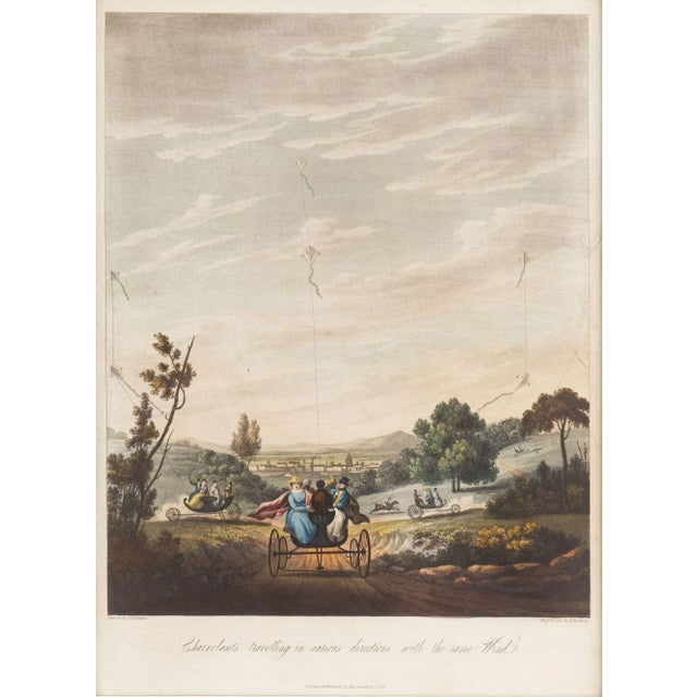 English hand colored engraving of four charvolents (carriages being pulled by kites) travelling through the countryside...