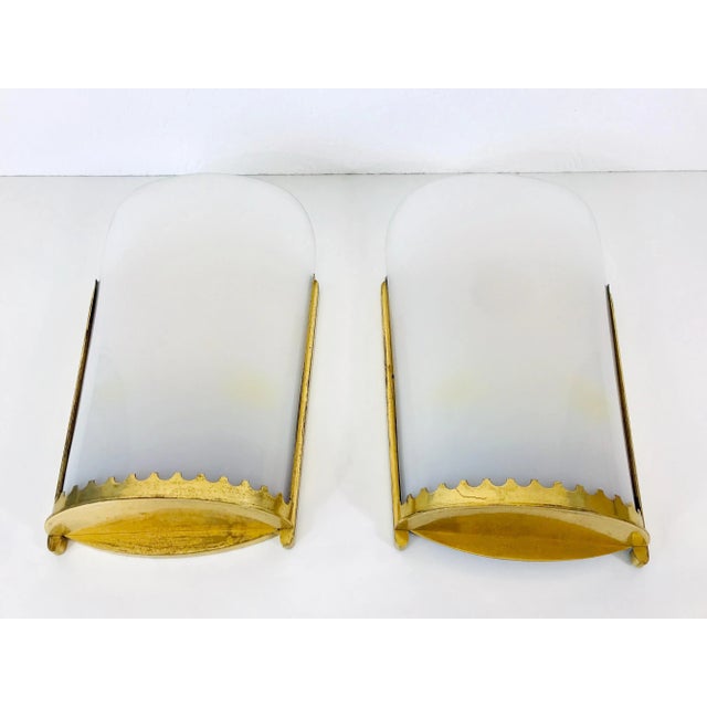 A pair of very large Mid-Century Modern wall lamps made in the 1950s.. They can perfectly be mounted on the wall. The...