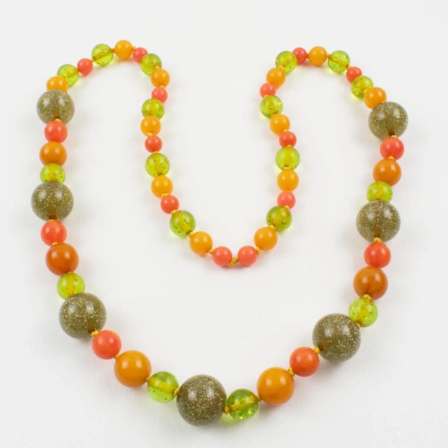 Superb extra-long Bakelite and Lucite beaded necklace. All rounded beads with assorted sizes and some with a pattern. Mix...