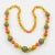 Superb extra-long Bakelite and Lucite beaded necklace. All rounded beads with assorted sizes and some with a pattern. Mix...